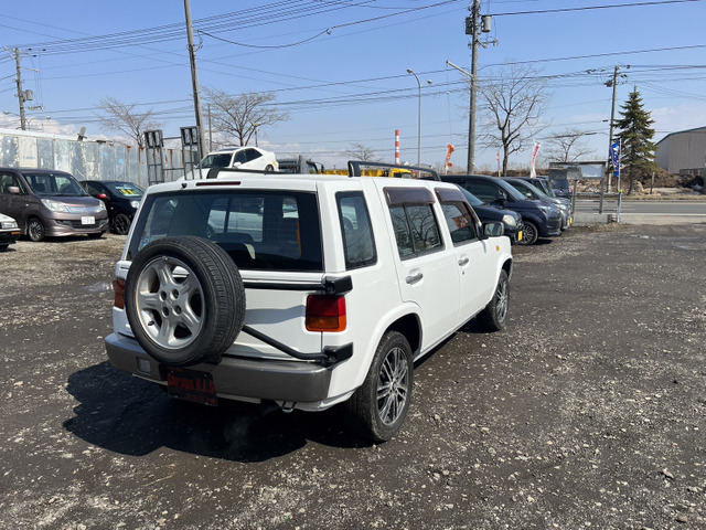 中古車 日産 ラシーン 1.5 タイプII 4WD ルーフレール背面タイヤ電動