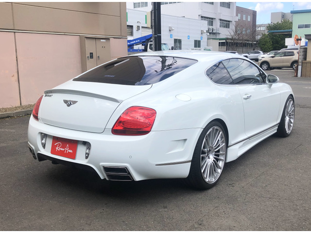 中古車 ベントレー コンチネンタルGT 6.0 4WD MANSORY色替元色赤 の