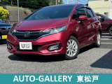 ワインレッド色のフィットハイブリッドLホンダセンシングが入庫しました。純正ナビ、バックカメラ装備のお車です。