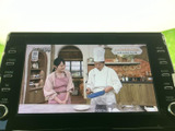 画面でテレビ番組を視聴できる装備です。停車中の待ち時間などに映像を楽しめるため、車内で過ごす時間の選択肢が広がります。使わないときはナビなどの画面に切り替えて活用できます。