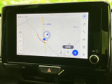 地図上に現在地や周辺道路が表示され、行き先の確認に役立ちます。画面上の検索や音声入力などのメニューも見やすく、初めての場所へ向かう際にも活用いただけます。