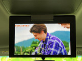 天井に設置されたモニターで映像を表示でき、停車中に番組や映像を楽しむ際にも活用できます。後席で過ごす時間の過ごし方に幅を持たせられる、車内で便利な装備です。