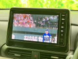 画面にはテレビ番組が表示され、停車中に映像を視聴できます。画面脇にメニューや音量などのボタンが並び、表示の切り替えや音量調整にも便利です。