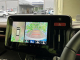 後方の映像に加えて車両周囲の表示も確認でき、駐車時の状況把握をサポートします。画面には進行方向の目安も表示され、後退時の確認に役立ちます。