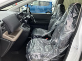 運転席まわりは前方の見通しがよく、着座したまま周囲を確認しやすい配置です。前席にはカバーが掛けられており、乗車する方を迎える清潔感も感じられます。