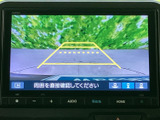 後方の様子を画面で確認しながら駐車でき、黄色いガイド線が車庫入れの目安になります。周囲を直接確認する案内も表示されるため、駐車時の安全確認をサポートする装備です。