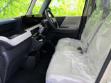 前席から運転席やダッシュボードまで見渡せる、開放感のある室内です。シートには保護カバーが掛けられ、乗り降りのしやすさや座席まわりの広さも伝わります。